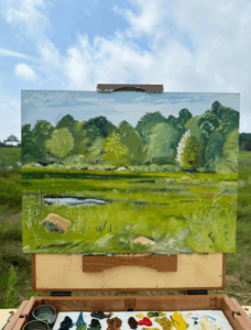 A painting of the marsh on an easel at Carvalho Farm